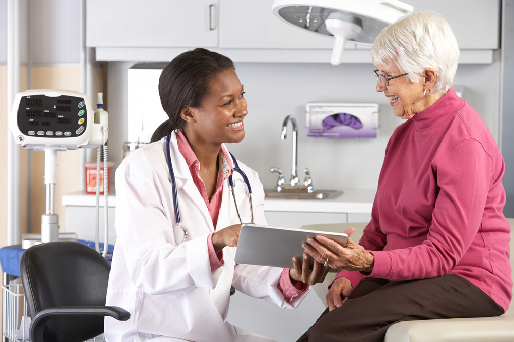 Doctor smiling and peaking with a smiling patient