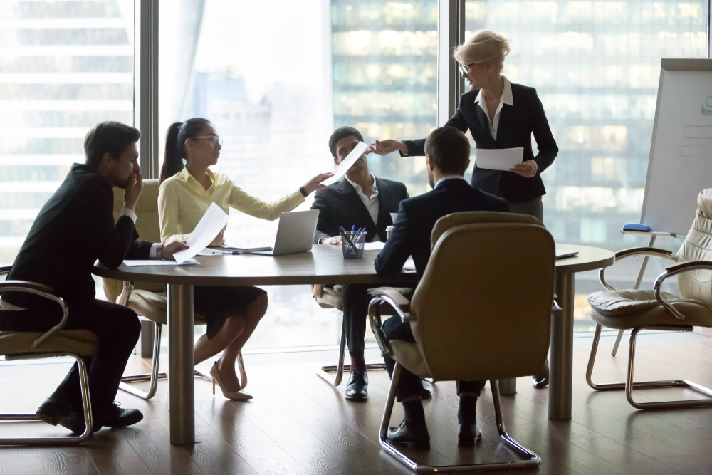 Business colleagues reviewing documents in a board room