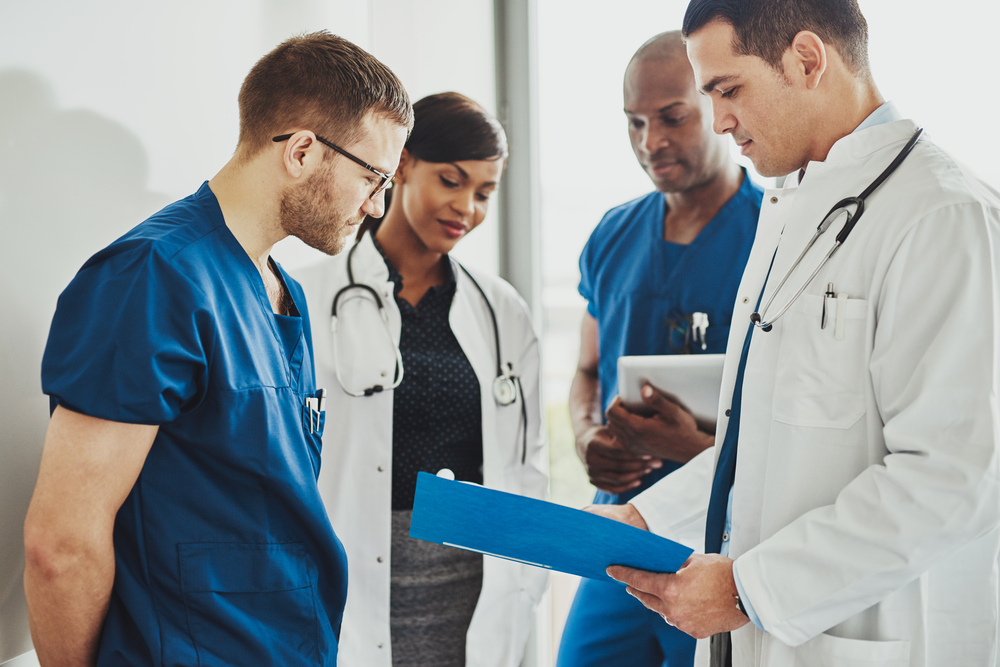 A group of healthcare professionals review files together