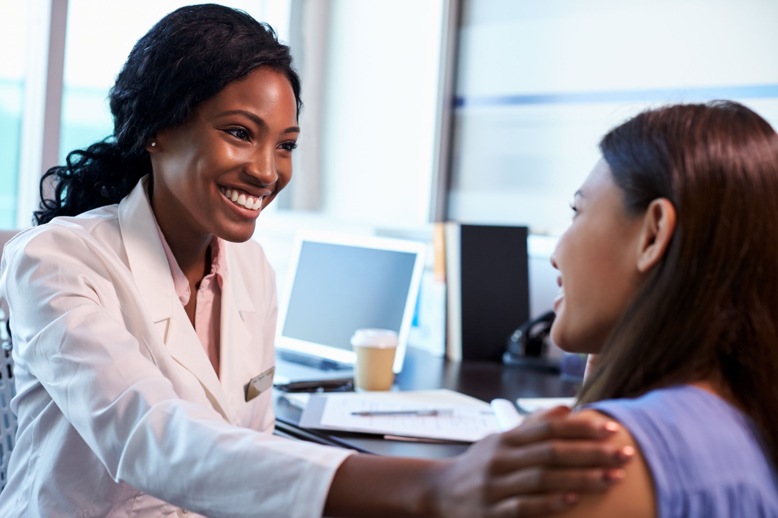 Doctor smiling and talking to a patient